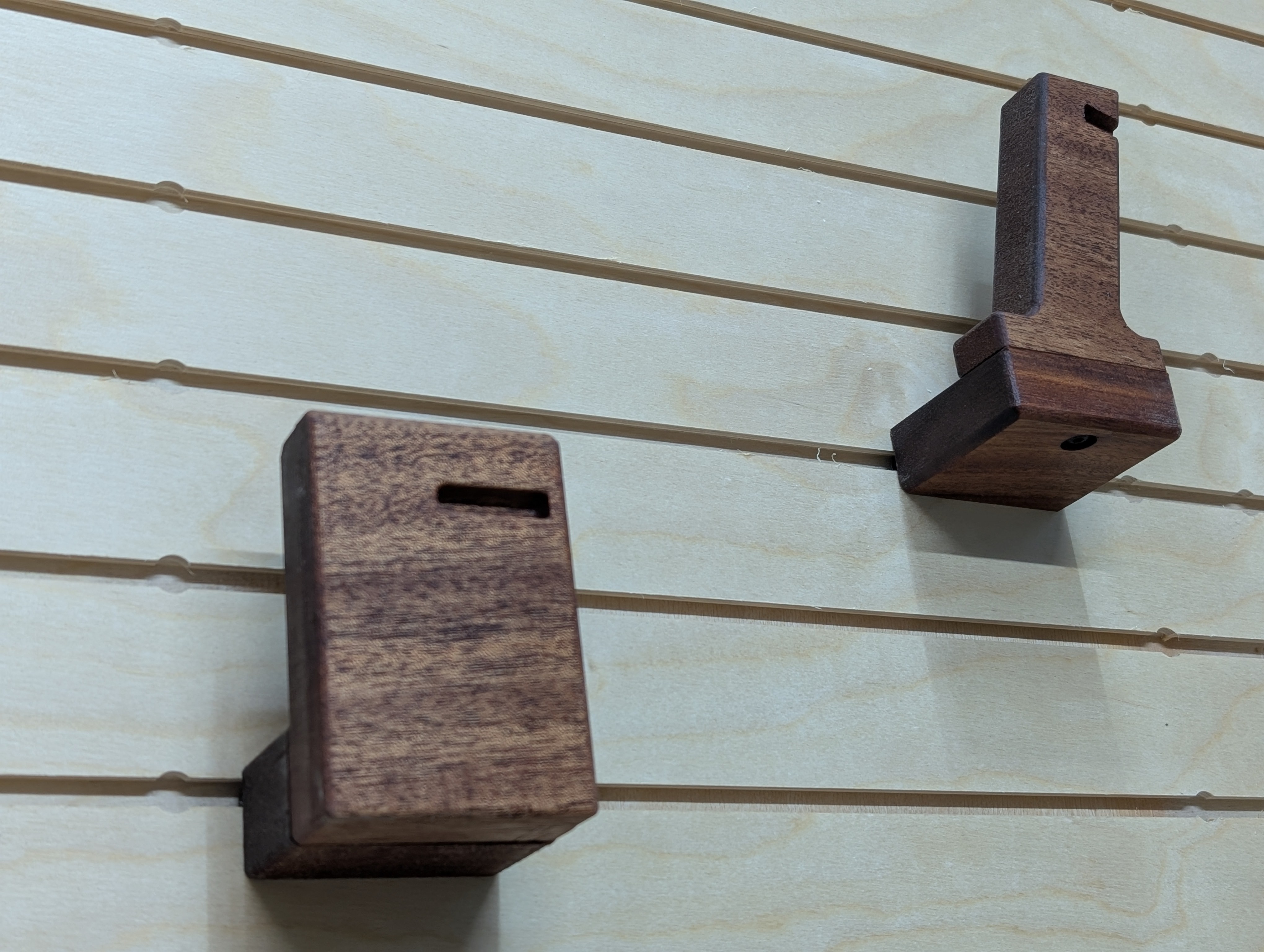 2 walnut gun mounts on a wall